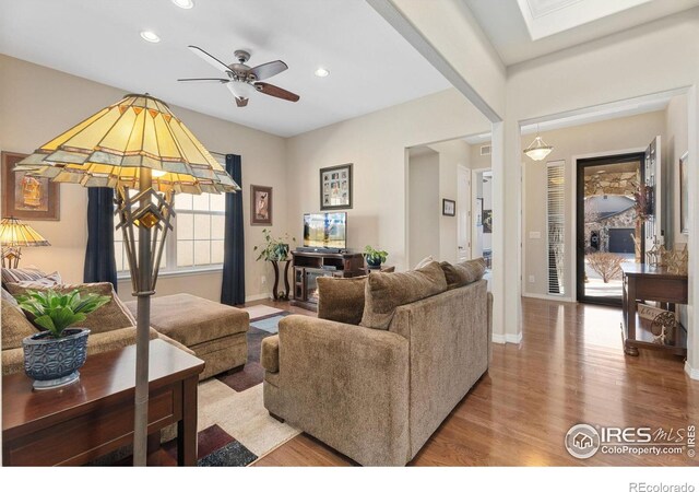living area featuring a ceiling fan, recessed lighting, wood finished floors, and baseboards