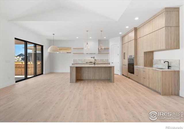 kitchen with modern cabinets, light brown cabinets, light countertops, open shelves, and recessed lighting
