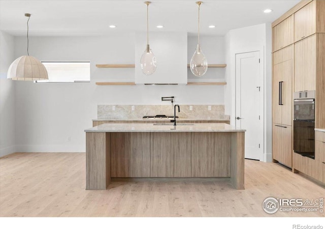 kitchen with open shelves, light wood-style flooring, a sink, modern cabinets, and recessed lighting
