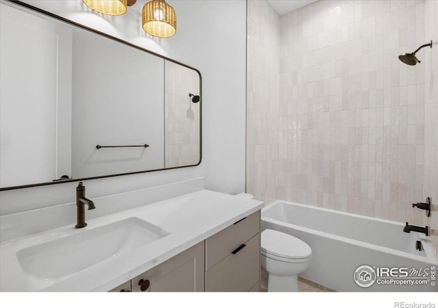 bathroom with toilet, vanity, and bathing tub / shower combination