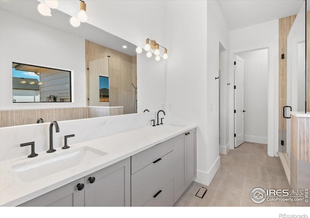 full bathroom with a stall shower, baseboards, tile patterned flooring, and double vanity