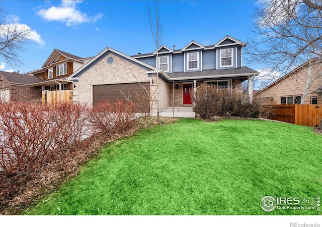 660 Fernglen Ct, Colorado Springs, CO 80906 - traditional-style house featuring brick siding, a garage, a front yard, and fence