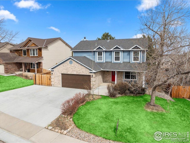 660 Fernglen Ct, Colorado Springs, CO 80906 - traditional home with a front lawn, fence, concrete driveway, an attached garage, and a shingled roof