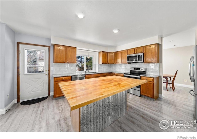660 Fernglen Ct, Colorado Springs, CO 80906 - kitchen with a sink, wooden counters, tasteful backsplash, and appliances with stainless steel finishes