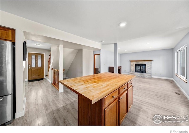 660 Fernglen Ct, Colorado Springs, CO 80906 - kitchen with visible vents, light wood-style flooring, butcher block counters, and freestanding refrigerator
