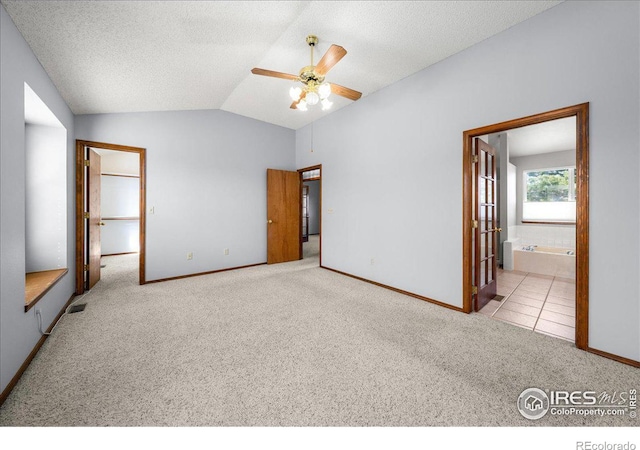 660 Fernglen Ct, Colorado Springs, CO 80906 - unfurnished bedroom with carpet flooring, a textured ceiling, baseboards, and vaulted ceiling