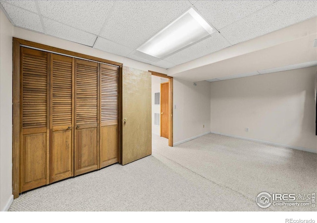 660 Fernglen Ct, Colorado Springs, CO 80906 - finished basement with visible vents, a paneled ceiling, baseboards, and light carpet