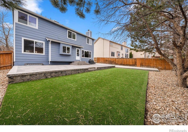 660 Fernglen Ct, Colorado Springs, CO 80906 - rear view of property with a fenced backyard, a lawn, entry steps, and a patio