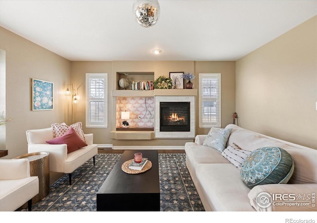 2120 Timber Creek Dr Unit 3, Fort Collins, CO 80528 - living area featuring a glass covered fireplace, a healthy amount of sunlight, and wood finished floors