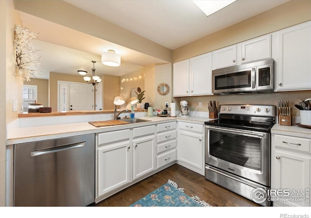 2120 Timber Creek Dr Unit 3, Fort Collins, CO 80528 - kitchen with an inviting chandelier, dark wood finished floors, white cabinets, and stainless steel appliances
