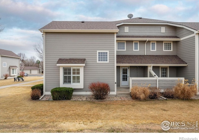 2120 Timber Creek Dr Unit 3, Fort Collins, CO 80528 - back of property featuring a lawn, a shingled roof, and covered porch