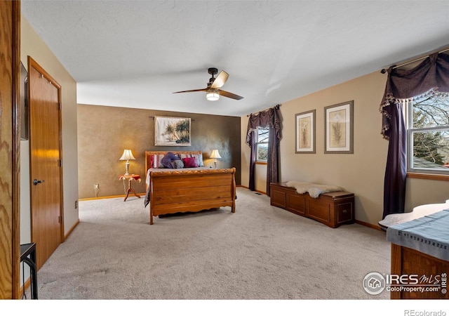 2418 Maplewood Cir E, Longmont, CO 80503 - carpeted bedroom featuring multiple windows, a ceiling fan, and baseboards