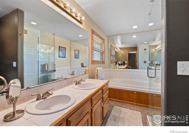 2418 Maplewood Cir E, Longmont, CO 80503 - full bathroom featuring a garden tub, a shower stall, double vanity, recessed lighting, and tasteful backsplash