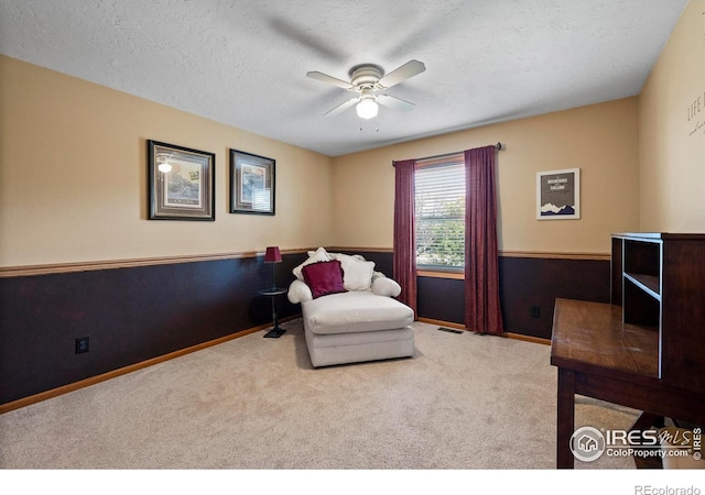 2418 Maplewood Cir E, Longmont, CO 80503 - sitting room featuring ceiling fan, carpet floors, baseboards, and a textured ceiling