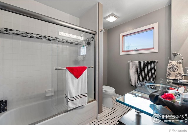 2418 Maplewood Cir E, Longmont, CO 80503 - bathroom featuring toilet, enclosed tub / shower combo, and vanity
