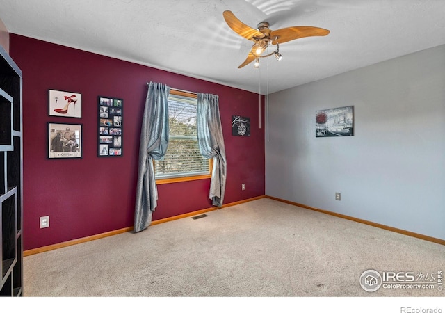 2418 Maplewood Cir E, Longmont, CO 80503 - spare room featuring carpet floors, a ceiling fan, and baseboards