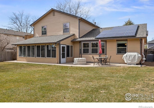 2418 Maplewood Cir E, Longmont, CO 80503 - rear view of house with solar panels, a sunroom, a patio area, a shingled roof, and cooling unit