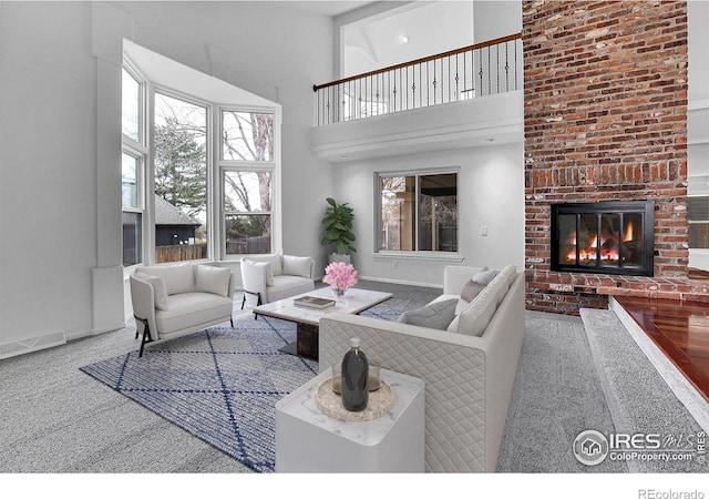 10895 W Half Moon Pass, Littleton, CO 80127 - living room with carpet flooring, a brick fireplace, baseboards, and a towering ceiling