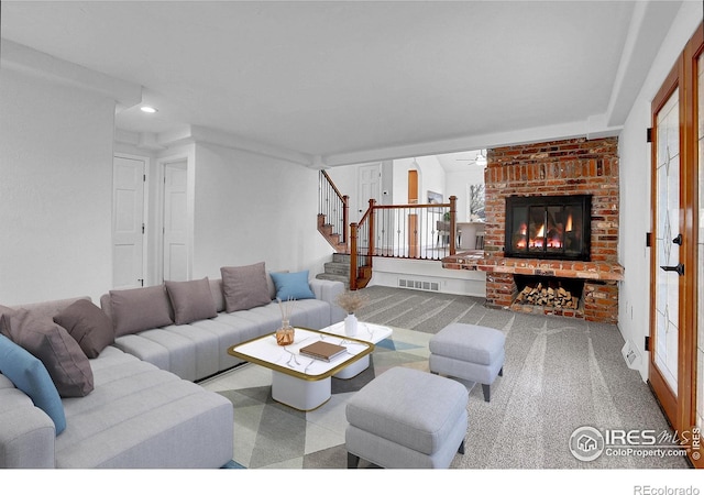 10895 W Half Moon Pass, Littleton, CO 80127 - living room featuring stairs, a brick fireplace, a ceiling fan, and carpet flooring