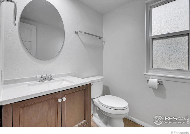 10895 W Half Moon Pass, Littleton, CO 80127 - bathroom with vanity, toilet, and baseboards