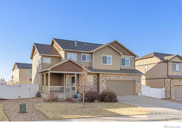 view of front of house with a porch, concrete driveway, an attached garage, and fence