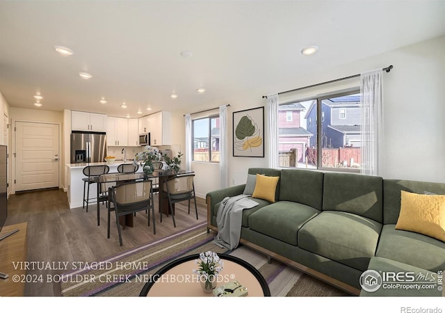 living area featuring recessed lighting and dark wood-style floors