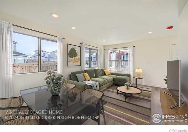 living area with recessed lighting, wood finished floors, and baseboards