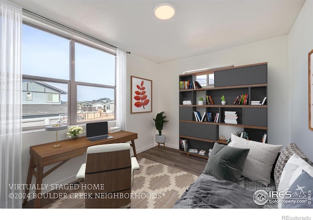 home office featuring baseboards and wood finished floors