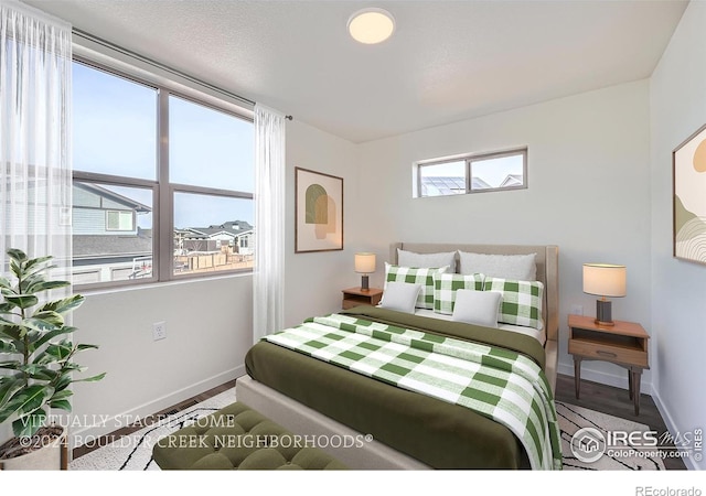 bedroom featuring baseboards and wood finished floors