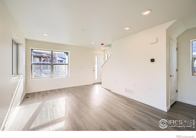 empty room with visible vents, recessed lighting, wood finished floors, and baseboards