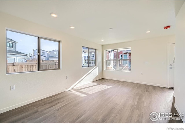 unfurnished room featuring recessed lighting, visible vents, baseboards, and wood finished floors