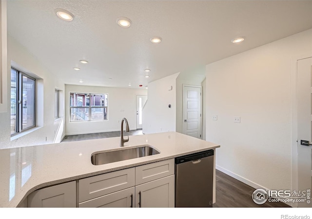 kitchen with a sink, dishwasher, recessed lighting, white cabinetry, and dark wood-style flooring