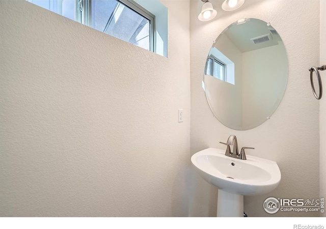 bathroom with a sink and visible vents