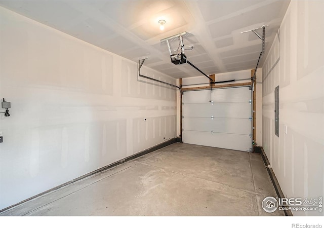 garage with electric panel and a garage door opener