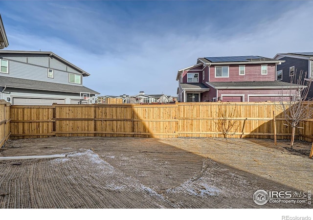 view of yard with a residential view and a fenced backyard