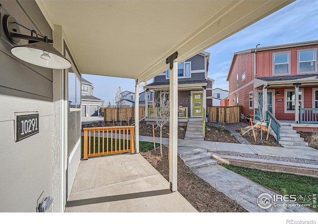 view of patio with covered porch and fence