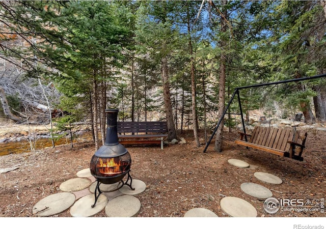 view of yard with an outdoor fire pit