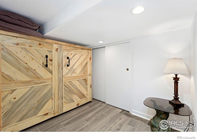 interior space with light wood-type flooring, baseboards, and recessed lighting