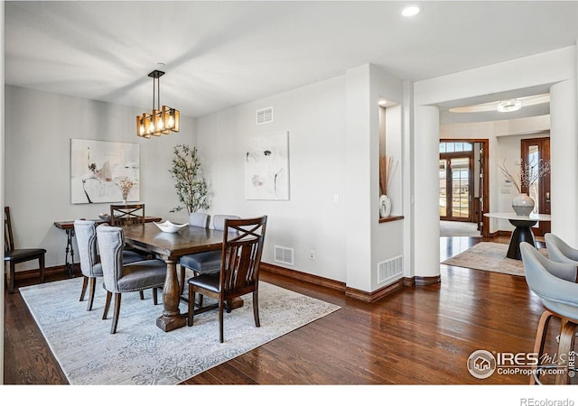 dining area with visible vents and wood finished floors