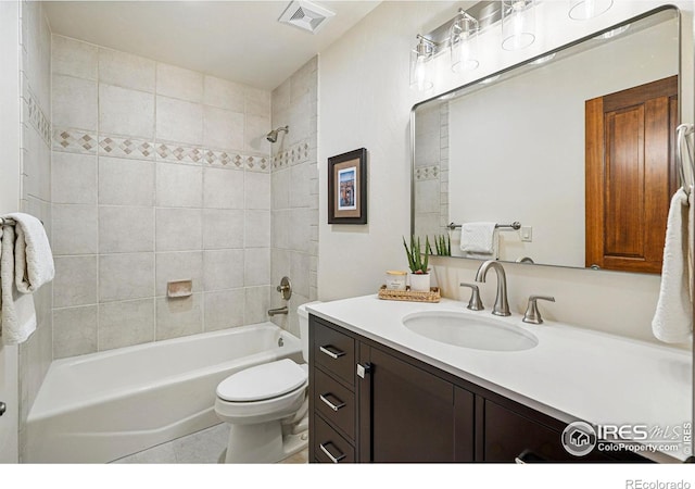 full bathroom featuring washtub / shower combination, visible vents, toilet, and vanity