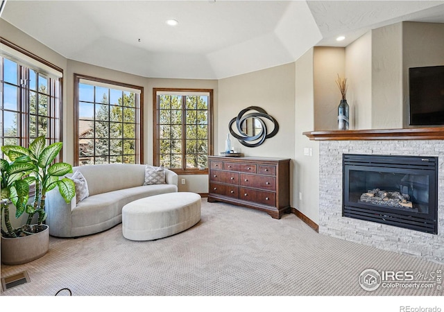 living area featuring visible vents, recessed lighting, a stone fireplace, carpet flooring, and baseboards