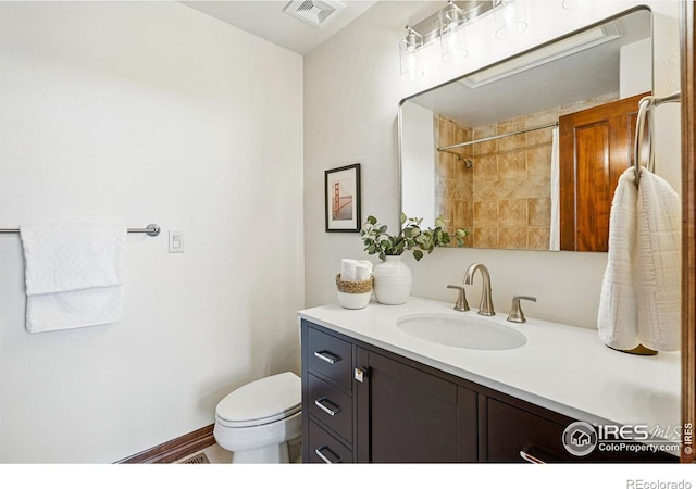 full bath featuring vanity, toilet, a shower, and visible vents