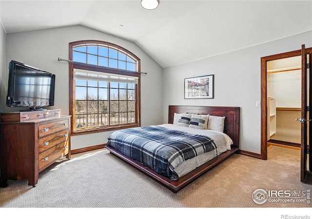 bedroom featuring baseboards, lofted ceiling, and carpet floors