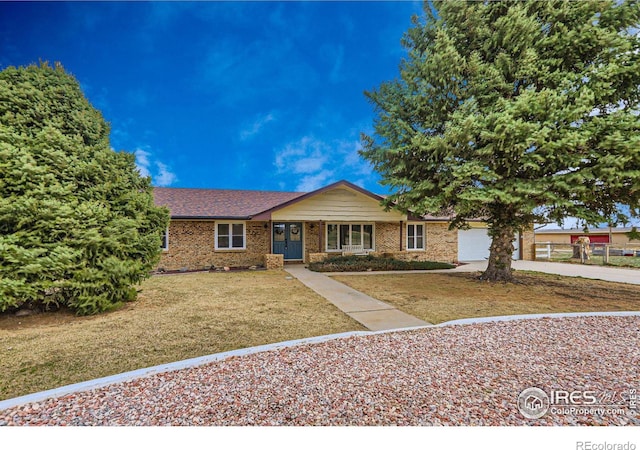 ranch-style house with a garage, brick siding, concrete driveway, and a front lawn