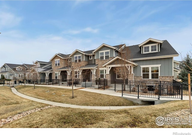 2453 Trio Falls Dr, Loveland, CO 80538 - view of front of house with stone siding, board and batten siding, and a residential view