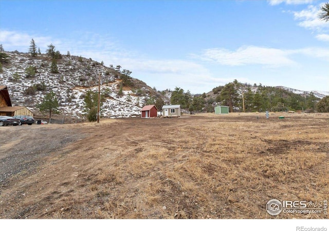 59 W Rustic Rd, Bellvue, CO 80512 - view of yard featuring a storage unit, an outdoor structure, and a mountain view