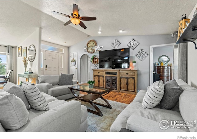 5621 W 27th St, Greeley, CO 80634 - living area featuring a textured ceiling, lofted ceiling, a ceiling fan, and wood finished floors