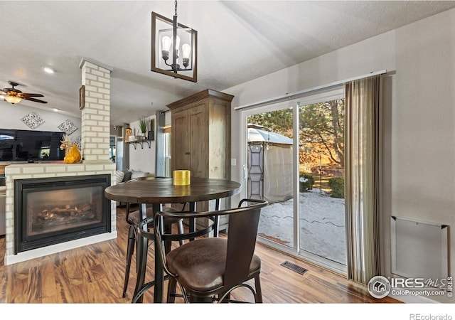 5621 W 27th St, Greeley, CO 80634 - dining room with visible vents, a brick fireplace, ceiling fan, and light wood finished floors