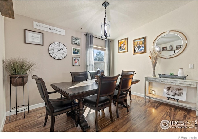 5621 W 27th St, Greeley, CO 80634 - dining area featuring lofted ceiling, wood finished floors, baseboards, and a textured ceiling