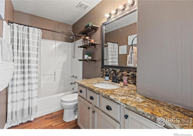 5621 W 27th St, Greeley, CO 80634 - bathroom with vanity, wood finished floors, visible vents, shower / tub combo, and a textured ceiling